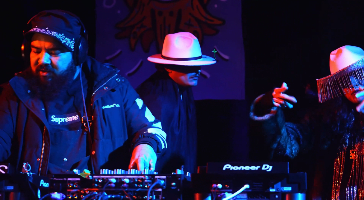 Close-up of SERGIK performing with dramatic red-orange and blue lighting